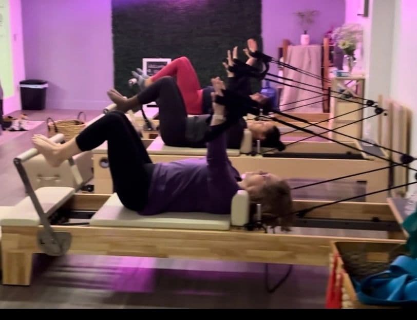 Two clients on reformers at Bronzeville Pilates